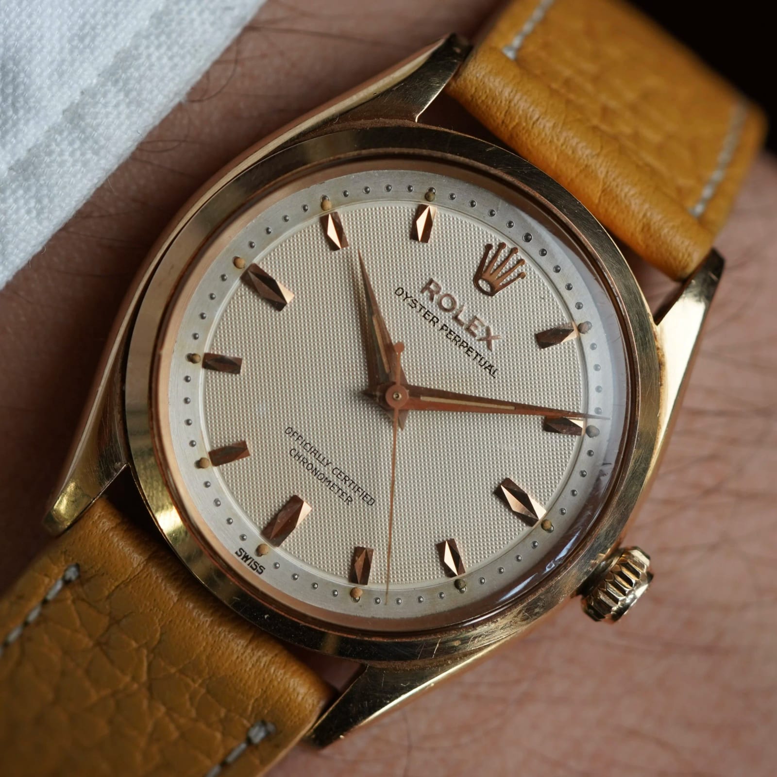Reference image of a Rolex Oyster Perpetual 6564 with honeycomb dial on a leather strap